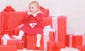 Family holiday. Little baby girl play near pile of gift boxes. Gifts for child first christmas. Celebrate first Royalty Free Stock Photo