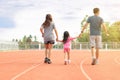 Family holiday Parents take their daughters to walk and run. And playing exercise at the stadium happily and having fun While Royalty Free Stock Photo