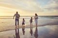 Family on holiday running on the beach. Family having fun in the ocean at sunset. Happy family running in the water at Royalty Free Stock Photo