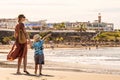 Family holiday on Tenerife, Spain. Mother with son walking on the sandy beach. Royalty Free Stock Photo