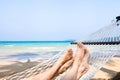 Family holidays on the beach, feet of couple in hammock, relaxation