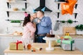 Family, holidays and people concept - mother, father and happy little son at home birthday party, parents are kissing Royalty Free Stock Photo