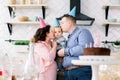 Family, holidays and people concept - mother, father and happy little son at home birthday party, parents are kissing Royalty Free Stock Photo