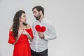 Family, holidays, Valentine`s Day. Love people concept - a big plan. Hold the red paper heart. White background. Dressed Royalty Free Stock Photo