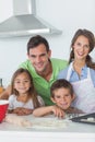 Family home baking together in the kitchen