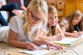 Family at home, the children coloring on floor