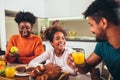 Family at home eating breakfast in kitchen together Royalty Free Stock Photo