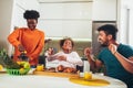 Family at home eating breakfast in kitchen together Royalty Free Stock Photo