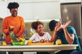 Family at home eating breakfast in kitchen together Royalty Free Stock Photo