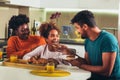 Family at home eating breakfast in kitchen together Royalty Free Stock Photo