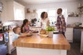 Family At Home Eating Breakfast In Kitchen Together Royalty Free Stock Photo
