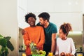 Family at home eating breakfast in kitchen together, having fun Royalty Free Stock Photo