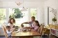 Family At Home Eating Meal In Kitchen Together Royalty Free Stock Photo