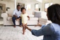 Family At Home Encouraging Baby Daughter To Take First Steps Royalty Free Stock Photo