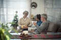 Family at home enjoying and celebrating christmas time night together with presents and gits for traditional exchange -  happy Royalty Free Stock Photo