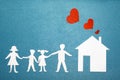 Family and home love concept. Paper house and family on blue textured background. Red hearts from pipe at home. Happy family. Royalty Free Stock Photo