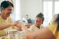 Family home, lunch and holding hands for praying together, religion or faith with comic girl child at table. Grandmother Royalty Free Stock Photo
