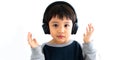 Family, home, technology and music concept. Portrait Young little Asian boy listening music with headphones at home. School child Royalty Free Stock Photo