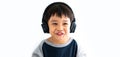 Family, home, technology and music concept. Portrait Young little Asian boy listening music with headphones at home. School child Royalty Free Stock Photo