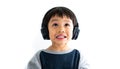 Family, home, technology and music concept. Portrait Young little Asian boy listening music with headphones at home. School child Royalty Free Stock Photo