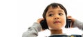 Family, home, technology and music concept. Portrait Young little Asian boy listening music with headphones at home. School child Royalty Free Stock Photo