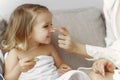 Mother with daughter in bathrobe and towels Royalty Free Stock Photo