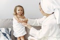 Mother with daughter in bathrobe and towels Royalty Free Stock Photo