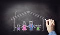 Family in house drawing on blackboard concept for home, construction, insurance or safety