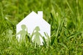 Family with house in a green grass