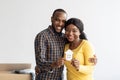 Family Housing Concept. Joyful Black Couple Holding Paper House Figure In Hands Royalty Free Stock Photo