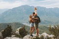 Family hugging couple with child traveling outdoor hiking in mountains with kid