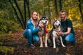 Family with husky dogs in the forest Royalty Free Stock Photo