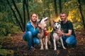 Family with husky dogs in the forest Royalty Free Stock Photo