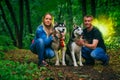 Family with husky dogs in the forest Royalty Free Stock Photo