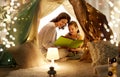 Happy family reading book in kids tent at home Royalty Free Stock Photo