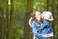 Caucasian Mother with Her Little Daughter Posing Together in Green Summer Forest Royalty Free Stock Photo