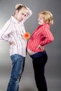 Family Ideas. Young Embarrassed Caucasian Couple Expecting Baby Standing Together Indoors While Holding Flower Between Them