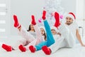 Family idyll, young parents and children in christmas morning sitting close to xmas tree at home in living room Royalty Free Stock Photo