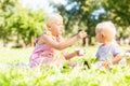 Older sister feeding her cute little brother