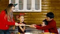 A family is joyfully pulling a piece of dough, baking together for Christmas Royalty Free Stock Photo