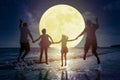 Family jumping on beach and watching the moon.Celebrate Mid autumn festival concept