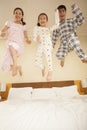 Family Jumping on Bed Together Royalty Free Stock Photo