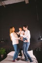 Family Jumping On Bed Together. Family fun. The beautiful family jumping on the bed. Caucasian mom dad and son active Royalty Free Stock Photo