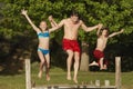 Family Jumping Into Lake Royalty Free Stock Photo