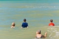 Family jumping waves at a tropical beach on the Gulf of Mexico