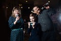 Family karaoke. Portrait of a happy family, singing in microphones Royalty Free Stock Photo