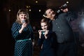 Family karaoke. Portrait of a happy family, singing in microphones