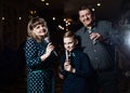 Family karaoke. Portrait of a happy family, singing in microphones Royalty Free Stock Photo