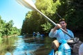 Family kayak trip. Father and daughter, and elderly couple senior and seniora rowing boat on the river, a water hike, a summer Royalty Free Stock Photo