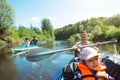 Family kayak trip. Father and daughter, and elderly couple senior and seniora rowing boat on the river, a water hike, a summer Royalty Free Stock Photo